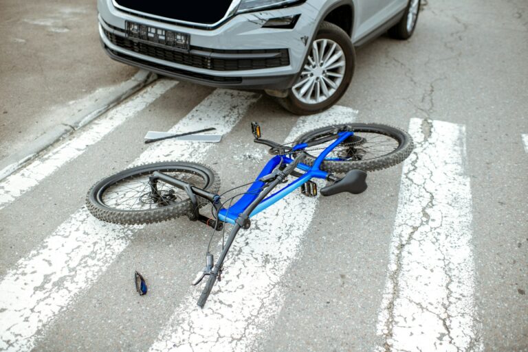 Road accident with car and broken bicycle